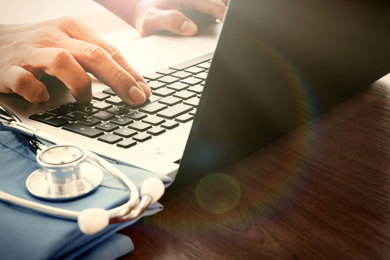 A doctor using a computer.