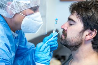 A man getting a nasal swab COVID-19 test.