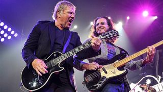 Guitarist Alex Lifeson, bassist Geddy Lee, and (cropped out) drummer Neil Peart of Rush performs at Bridgestone Arena on May 1, 2013 in Nashville, Tennessee.