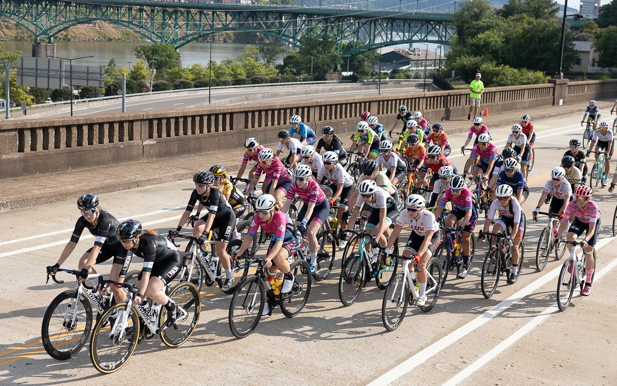The women's peloton, lead by the L39ION of Los Angeles lionesses, crosses the Hill Street Bridge between corner 1 and 2 for the first time.