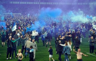 Everton fans celebrate on the pitch after the Premier League match at Goodison Park, Liverpool. Picture date: Thursday May 19, 2022.