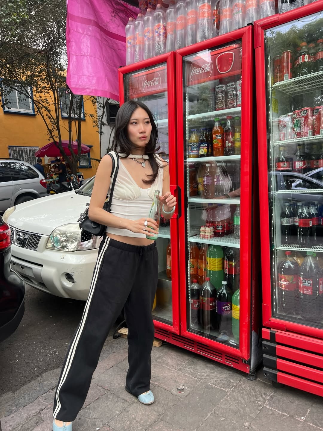 Woman in pretty top, track pants, and ballet flats
