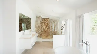 White bathroom with stone wall