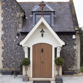 house entrance with wooden door and grey wall