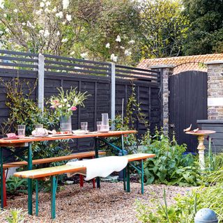 garden with dining table and benches