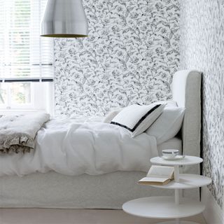 floral monochrome wallpaper double bed bedside table and chrome ceiling light