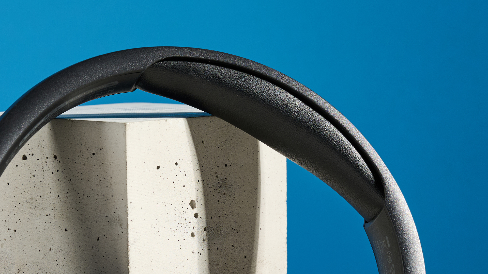 the belkin soundform isolate are a pair of budget headphones in black, with soft pillowy cups, control buttons on each cup, and ANC