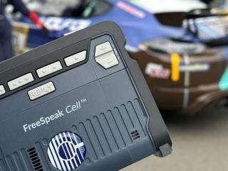 Clear-Com FreeSpeak Cell with a race car in background