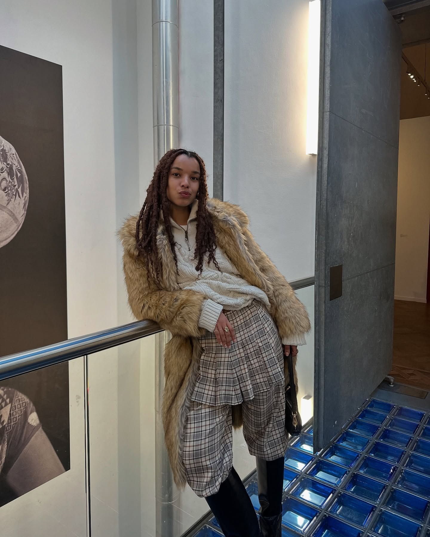 A woman wearing distressed locs.