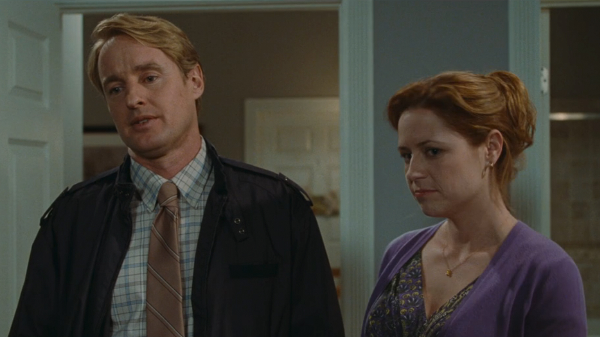 Owen Wilson on the left looking annoyed, standing next to Jenna Fischer on the right in Hall Pass