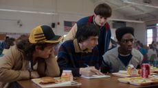 Gaten Matarazzo as Dustin Henderson, Finn Wolfhard as Mike Wheeler, Noah Schnapp as Will Byers, and Caleb McLaughlin as Lucas Sinclair in Stranger Things: Season 5