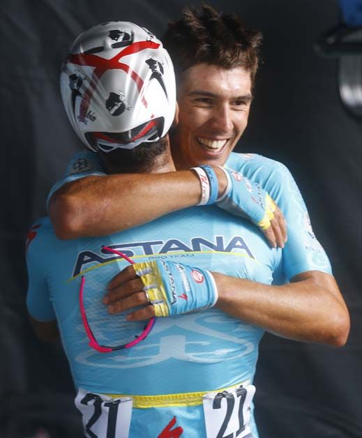 Diego Rosa and Fabio Aru hug after taking first and second