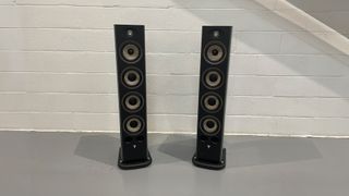 Focal Aria Evo X No3 floorstanding speakers on grey floor close to white brick wall