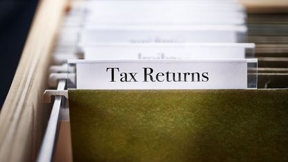 picture of a folder containing tax returns in a filing cabinet