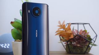 Nokia 8.3 5G standing upright on a table with its backside shown off