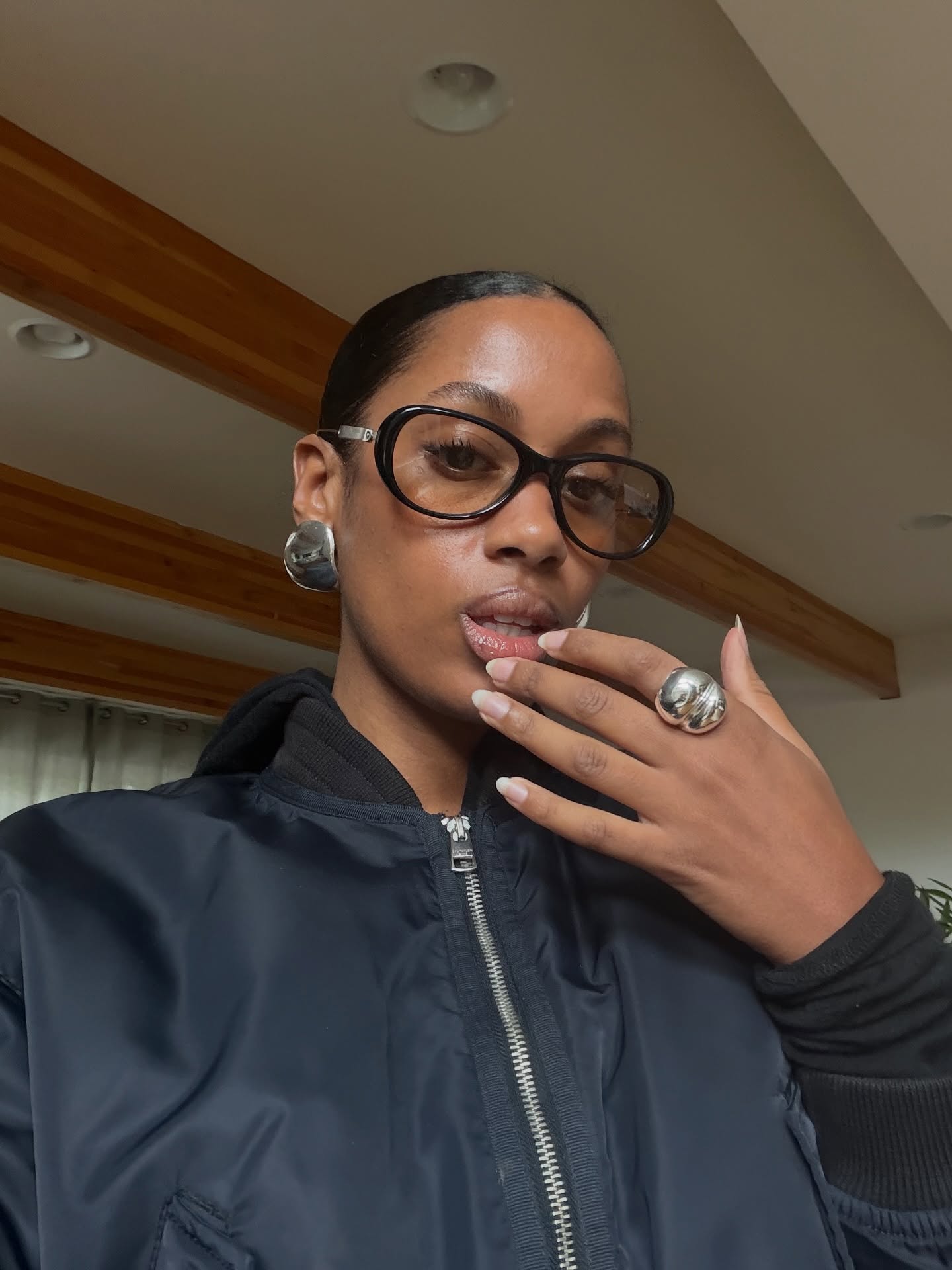 A selfie of @claire_most with a slicked-back bun and natural-looking nails