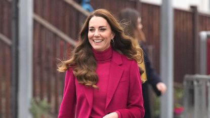 Kate Middleton, Duchess of Cambridge smiles as she arrives for a visit to Nower Hill High School on November 24, 2021 in London