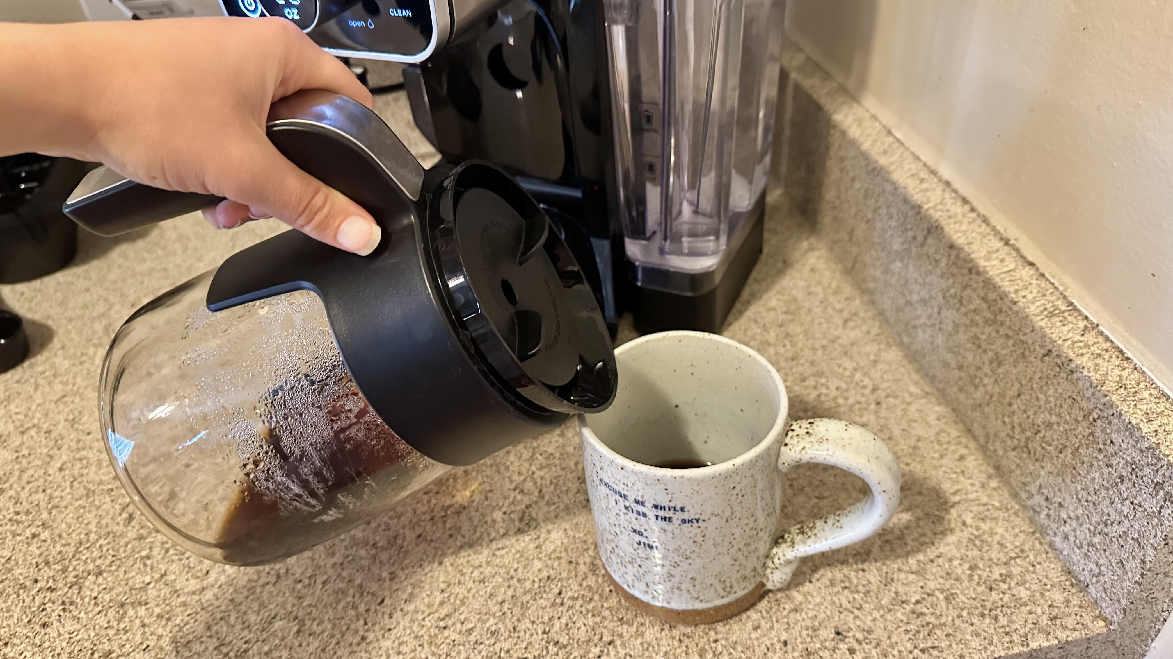 Using carafe to pour coffee with the Dual Brew