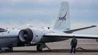 Photograph of the WB-57 jet on a runway being prepper for take off