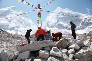 Sherpas, shown on April 13, 2014, at the Everest Base Camp, may be more adapted to breathing at high altitudes, compared with other climbers. Here the Sherpas are building a Budhhist puja altar before their ascent.