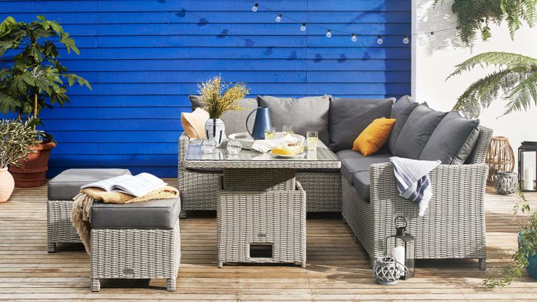 deck furniture ideas: decking with blue fence and Dorset Compact Corner Lounge Set with Rising Table from Furniture Village