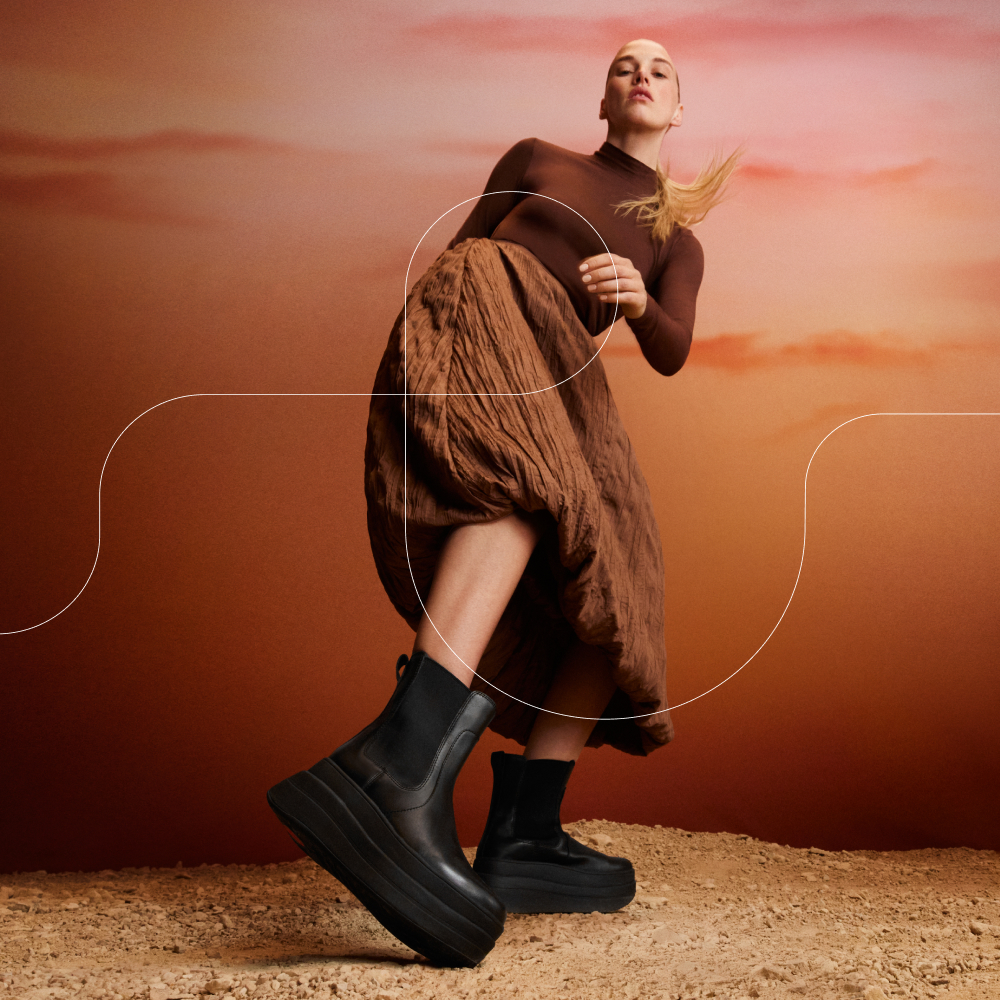 Model wearing black ankle boots sold at FitFlop