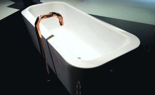White bathtub with copper tap