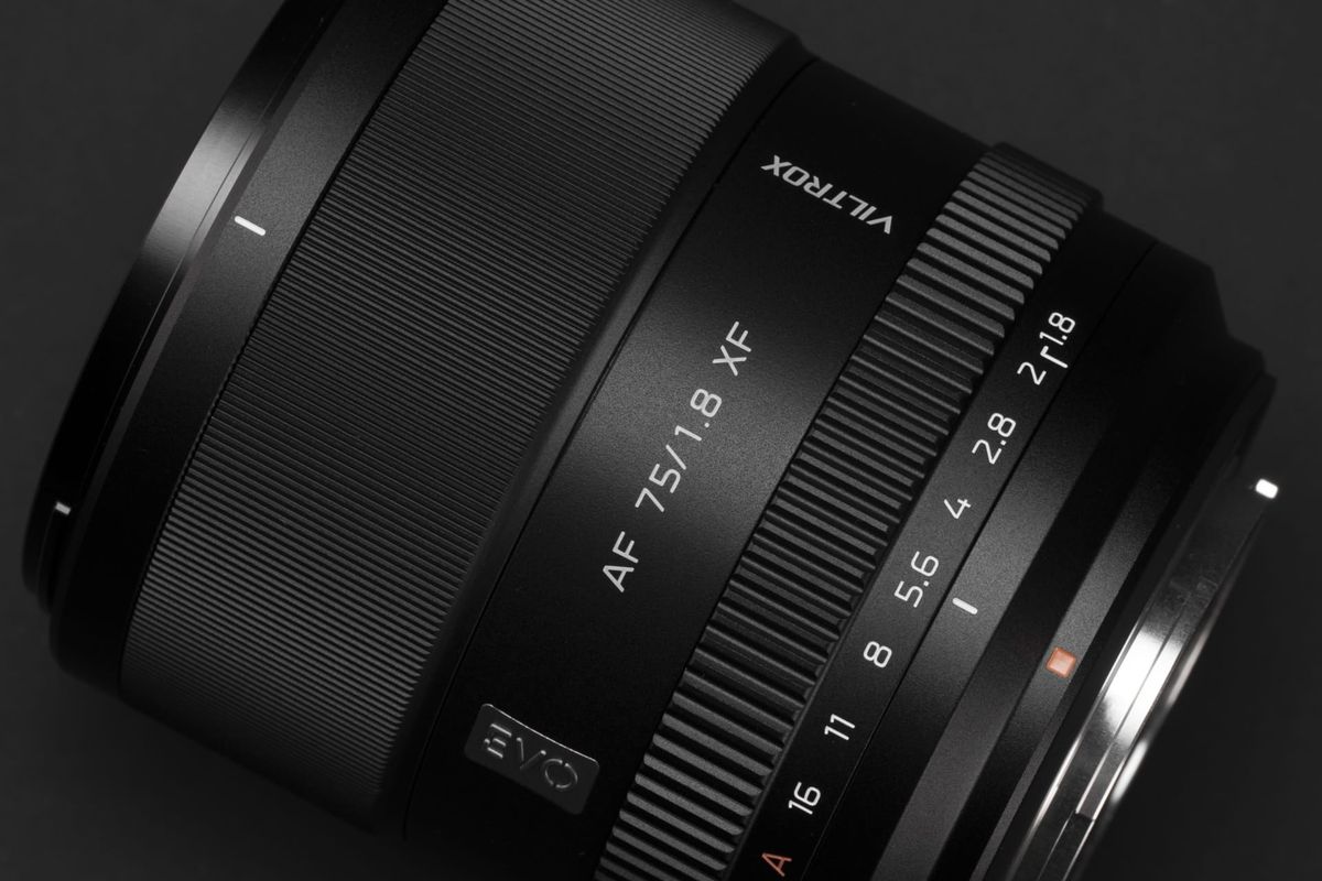 Close up of the Viltrox AF 75mm F1.8 EVO lens on a black background