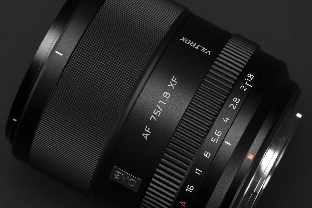 Close up of the Viltrox AF 75mm F1.8 EVO lens on a black background