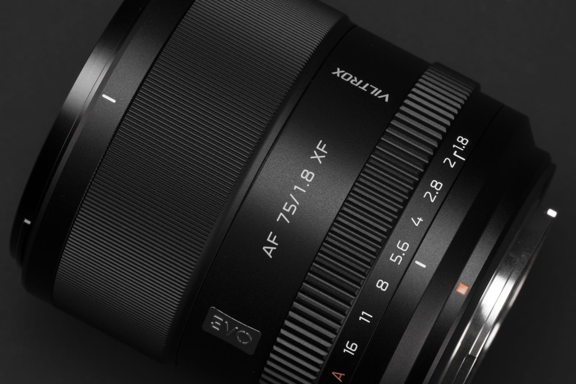 Close up of the Viltrox AF 75mm F1.8 EVO lens on a black background