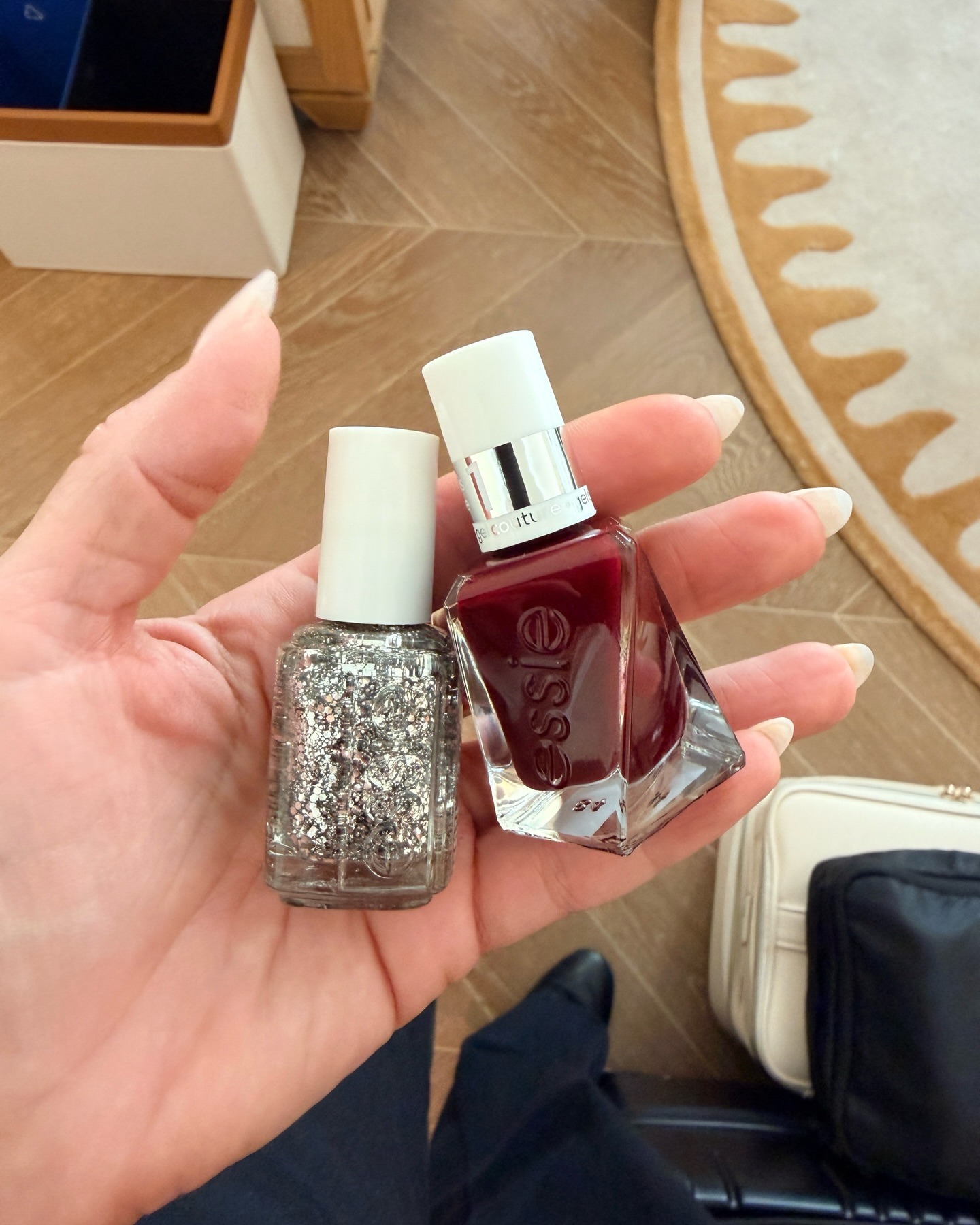 Julie K. holding two Essie nail polishes