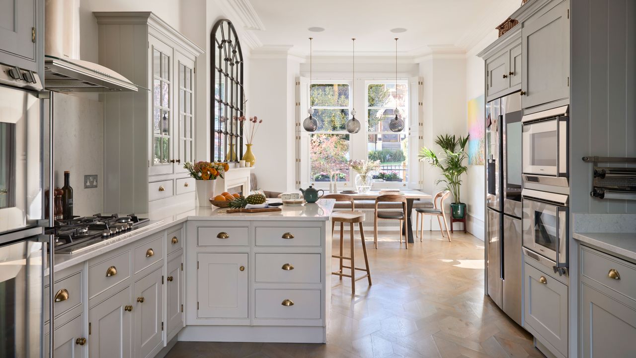 kitchen diner in a victorian home with white units and parquet floor