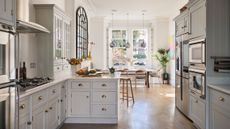 kitchen diner in a victorian home with white units and parquet floor