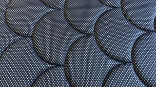 Close detail images of the DreamCloud Luxe Memory Foam mattress, showing design features like the quilted top of the bed and the handles sewn onto the sides