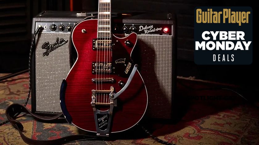 A photo of the Gretsch G6134TFM-NH Nigel Hendroff Signature Penguin leaning against a Fender combo