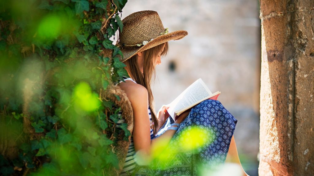 A girl reading a book outside