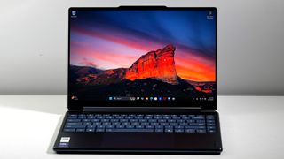 Lenovo Yoga 9i 2-in-1 Aura Edition open on a white desk, highlighting the vivid display.