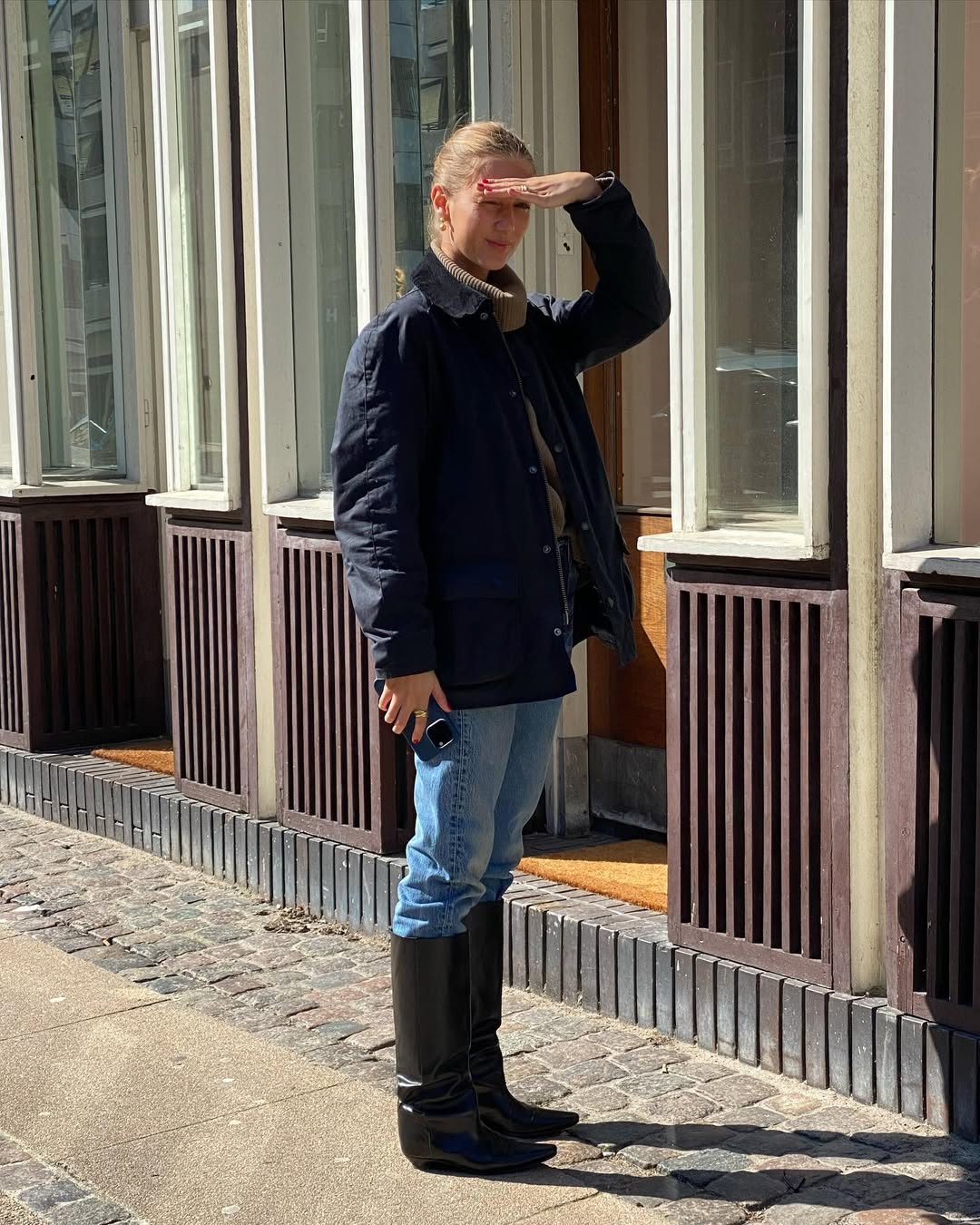 Amalie Moosgaard wearing knee-high boots with jeans