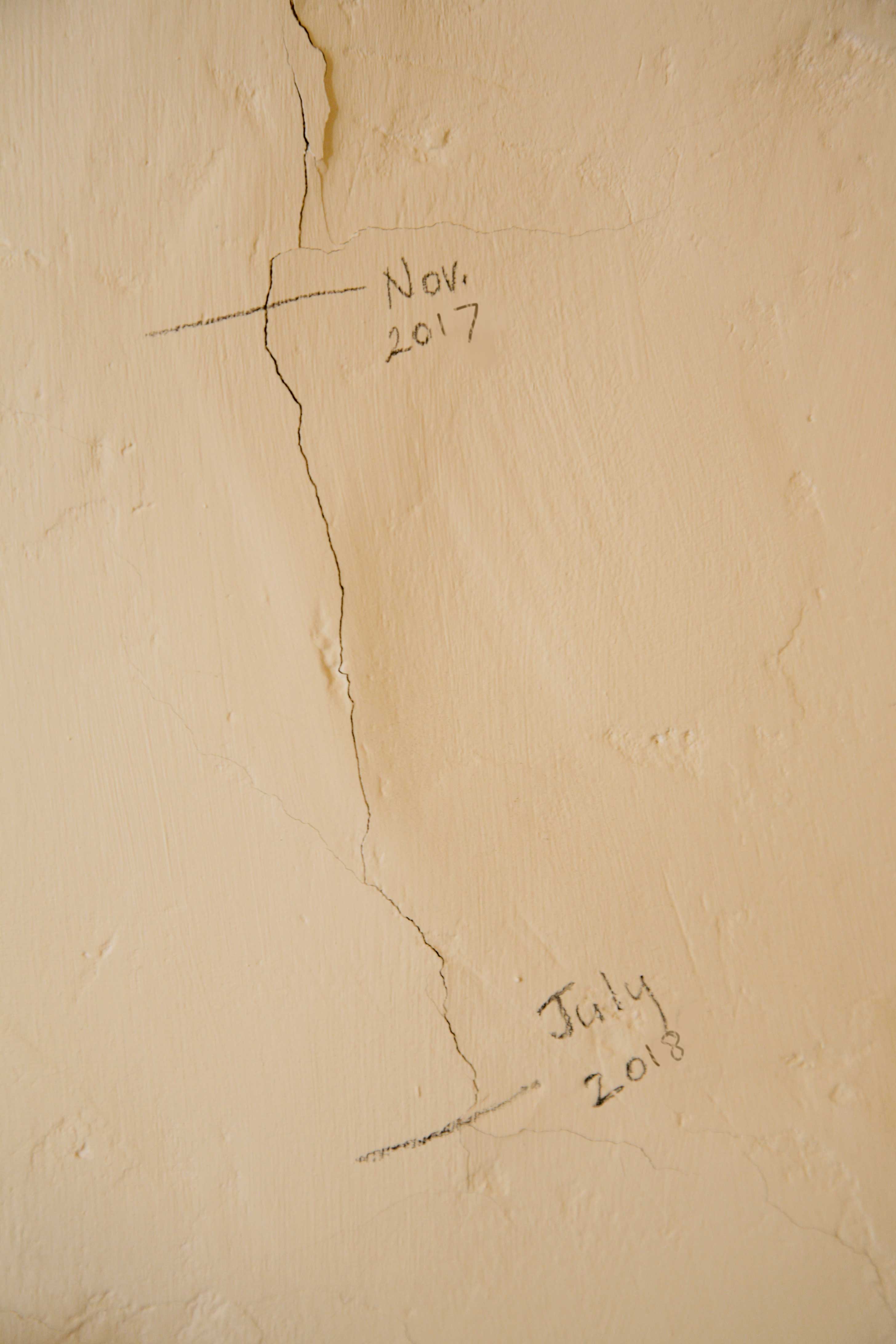 Recording cracks in wall with pencil marks