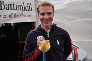 Nordic combined athlete and keen cyclist Bill Demong shows off his Olympic gold medal from the 2010 Vancouver Olympic Games.