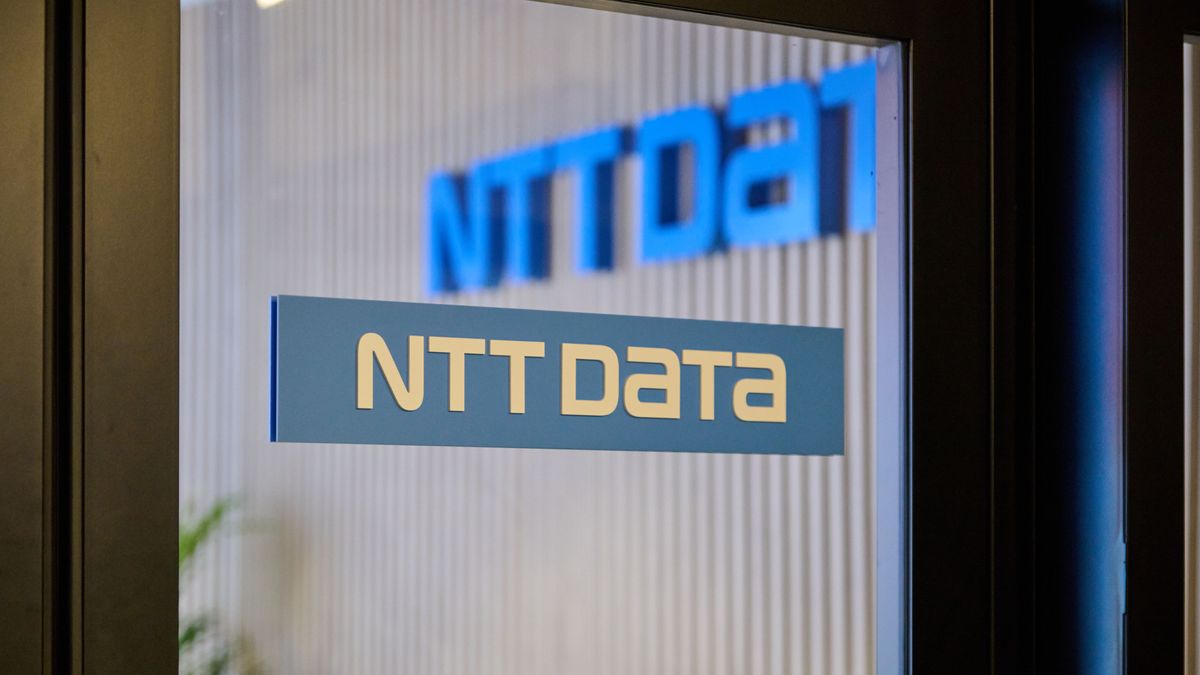 NTT Data logo on a glass door that looks out to the courtyard of the company&amp;#039;s offices