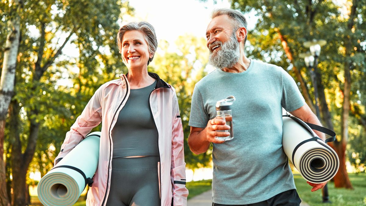 A photo of two older people heading out for exercise