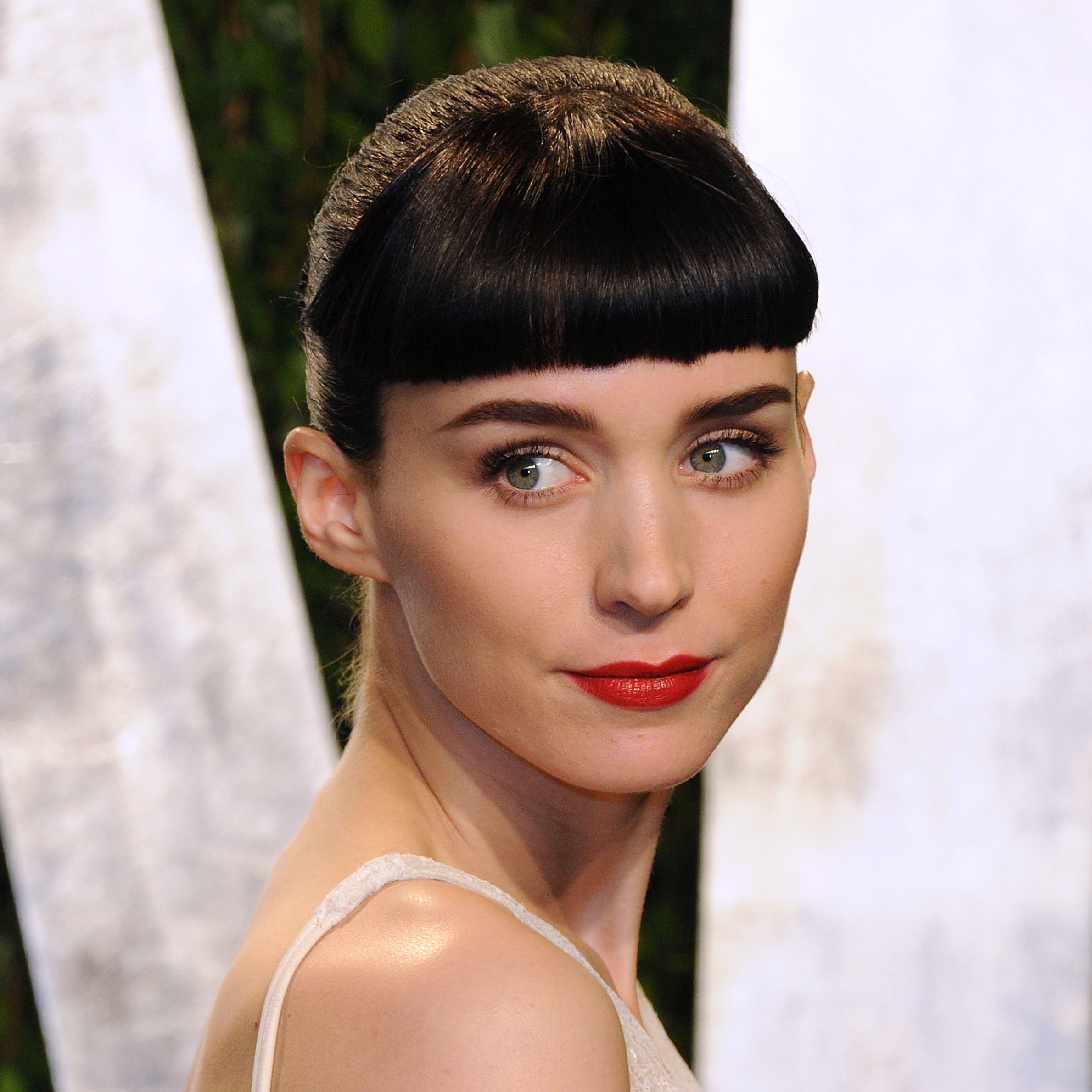 Rooney Mara wearing red lipstick and her iconic micro bangs.