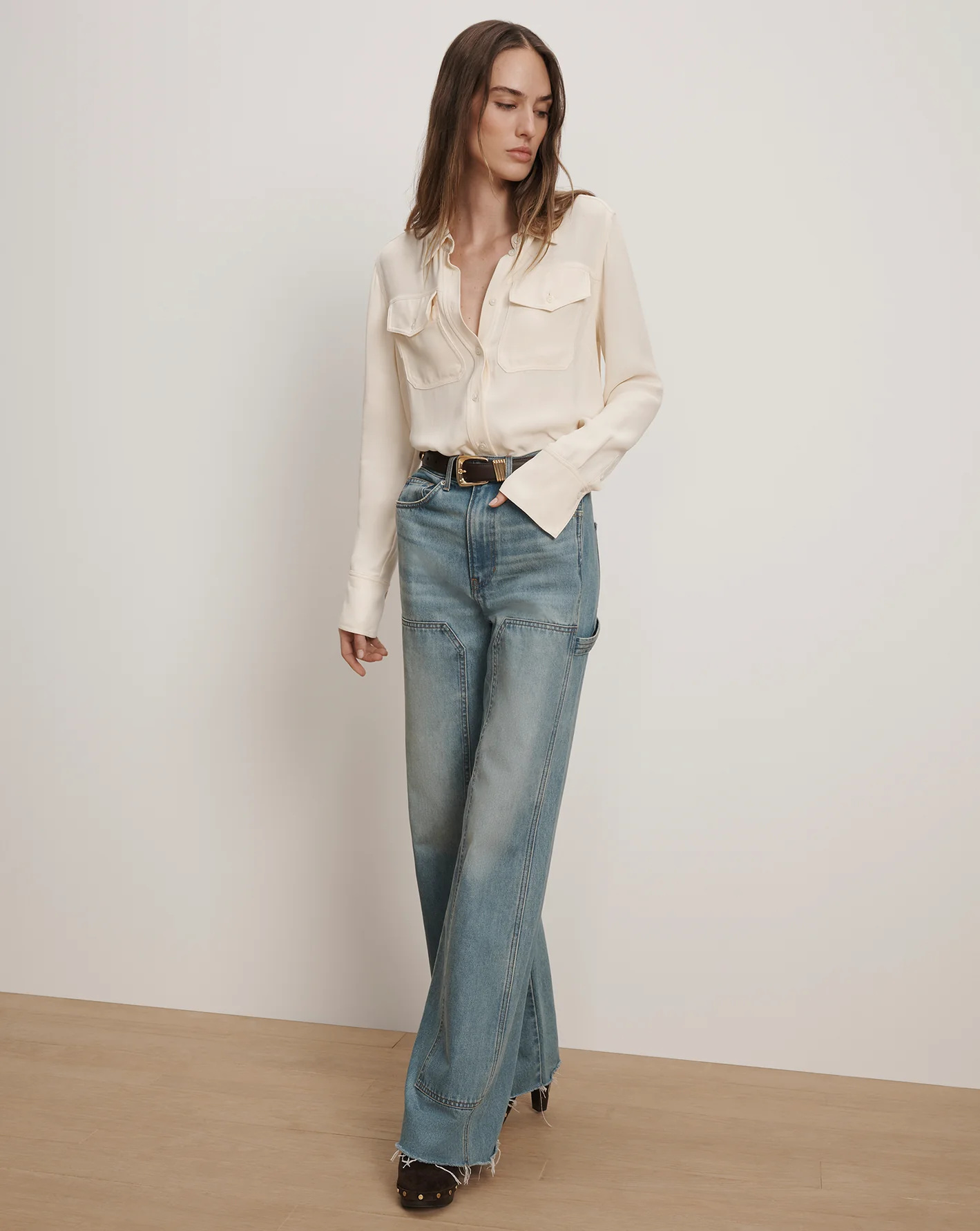 A model wears Veronica Beard cream blouse and jeans