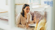 Woman having CBT for menopause in therapist's office with view looking through window