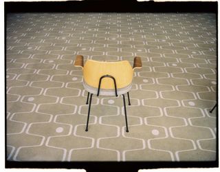 Chair by Robin Day photographed on a patterned carpet