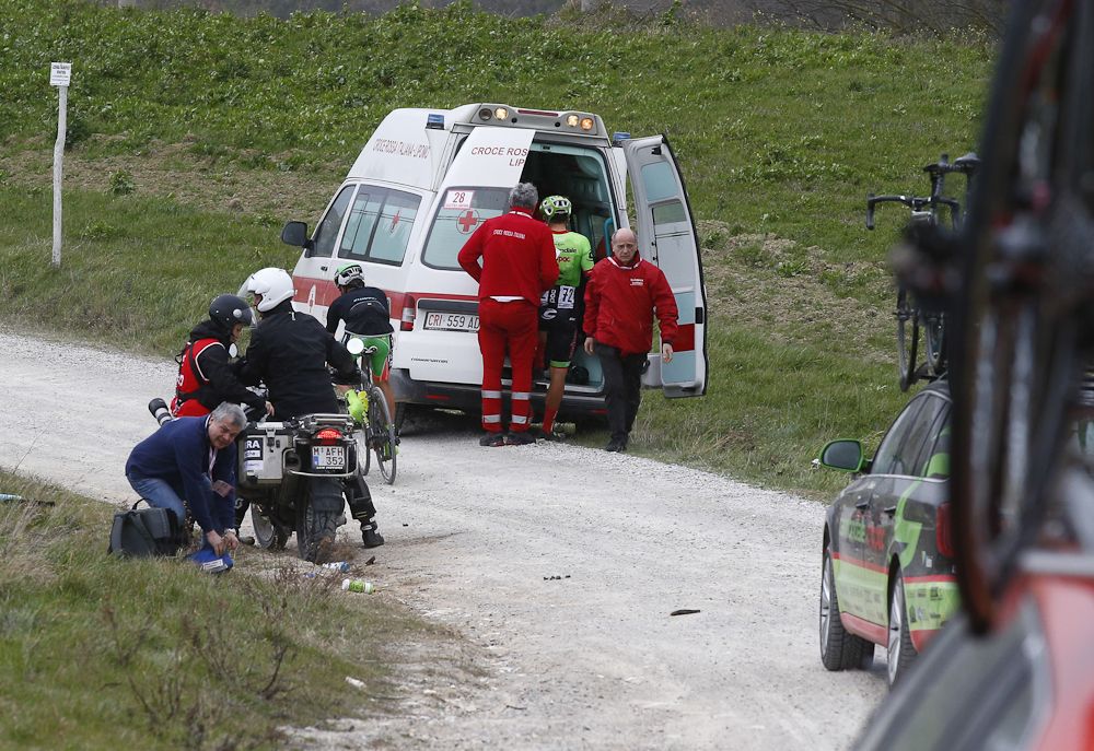 A crashed rider receives medical attention in Strade Bianche