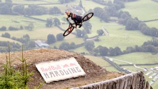 Rider does a whip over a jump at red bull hardline