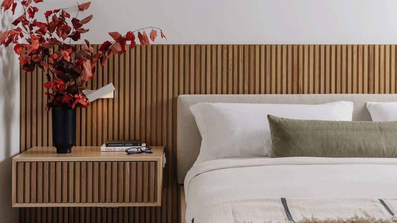 A bed against a wooden headboard