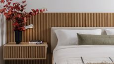 A bed against a wooden headboard